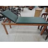 A vintage golden oak framed Doctor's examination bed by Reynolds & Branson having green