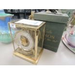 A vintage Le Coultre brass case Atmos, perpetual motion clock, in original box with instructions