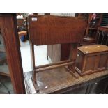 An early 20th century golden oak occasional table having drop leaf top