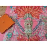 100 percent silk scarf having Hermes branding, rolled edges and brilliant bright pattern in what