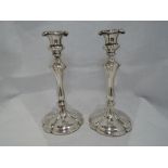 A pair of Elkington plate candle sticks of fluted baluster form having flower head style sconces and