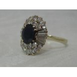 A lady's dress ring having an oval sapphire surrounded by baguette and bright cut diamonds, approx