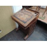 A Victorian walnut Davenport having stationery and slope inlay top over dummy and side drawers and