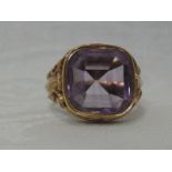 A gents yellow metal signet ring bearing French hallmarks having a facetted amethyst inset stone and