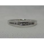 A lady's half eternity ring having 10 channel set diamond chips on an 18ct white gold loop, size L
