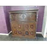 An 18th century and later oak court cupboard having extensive carved decoration, depicting tree of