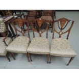 A set of three late Victorian/Edwardian rosewood standard chairs having line foliate, vase and