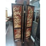 A Japanese design four fold room divider/screen having extra gilt heightened relief decoration