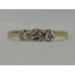 A lady's dress ring having a trilogy of diamonds, approx 0.189ct in a claw set mount on a yellow