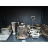 A selection of silver plate including coasters, cut glass basket with plated handle, biscuit