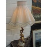 A vintage ormolu style table lamp modelled as cherub and branch