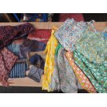 Selection of cheerful vintage aprons, some headscarves and neck scarves. Predominantly 1950s.