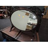 A late 19th century mahogany toilet/swing mirror having oval panel on shaped frame