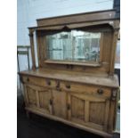 A late 19th century golden oak full height mirror backed sideboard having pillar support over