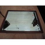 A wood framed bevelled edged mirror