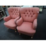 A pair of button back arm chairs