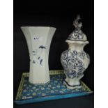 A Dutch Delft design blue and white vase having pictorial decoration and a similar lidded jar and