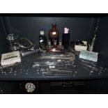 A selection of medical and surgical instruments including bottle set