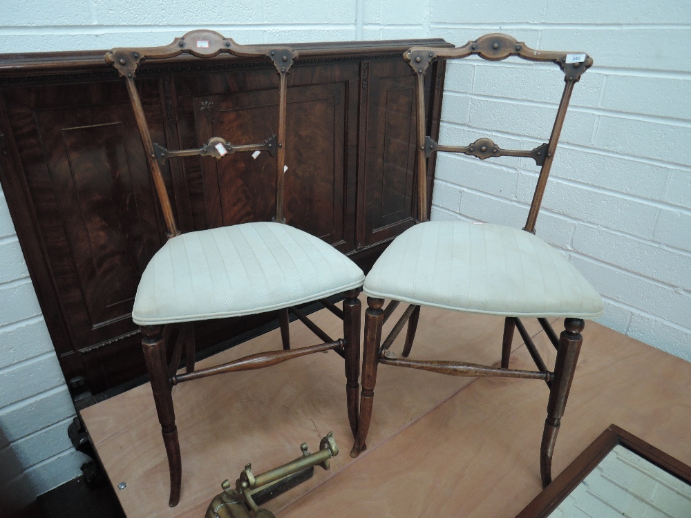 A pair of late Victorian mahogany aesthetic style occasional chairs having later upholstered seats