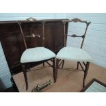 A pair of late Victorian mahogany aesthetic style occasional chairs having later upholstered seats