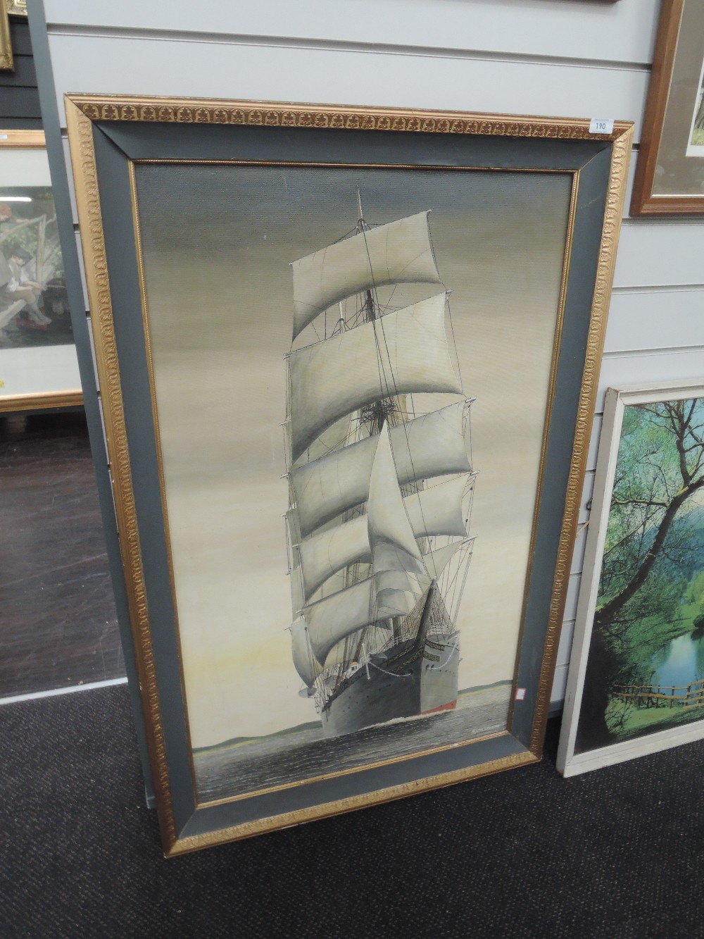 A large oil on board depicting sailing galleon signed Alan Lavin