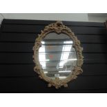 A gilt and plaster effect mirror