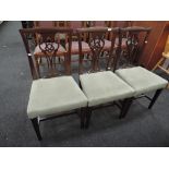 A set of three Edwardian mahogany dining chairs, having vase splats with later overstuffed seats and