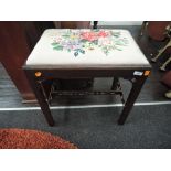 An embroidered top piano or similar stool