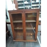 A mahogany and rolled glass display cabinet