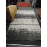 An 8'x 5' grey and cream rug