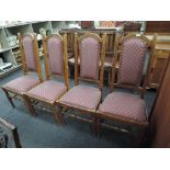 A set of four high backed dining chairs