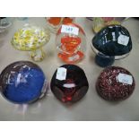 Six glass paperweights including Caithness