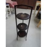 An early 20th Century dark stained cake stand