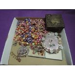 A selection of vintage costume jewellery including earrings, beads, brooches etc