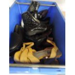 A mixed box of ladies shoes and boots in a variety of sizes and styles.