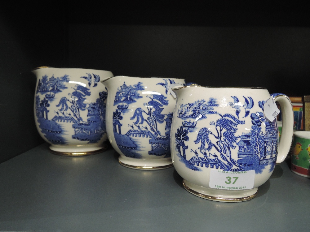 A set of graduated blue and white jugs by Sadler