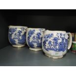 A set of graduated blue and white jugs by Sadler