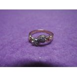 A lady's dress ring having two diamond chip set hearts to moulded crossover shoulders on a 9ct