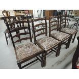 A set of four ladder back dining chairs