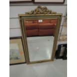A bevel edged mirror with gilt and plaster style frame