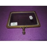 A vintage brass framed shaving or similar mirror by Hunts LTD