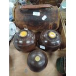 A selection of wooden crown green bowls by Thomas Taylor with leather case