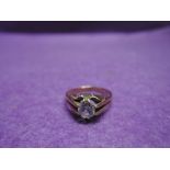 A yellow metal dress ring stamped 9ct having a cubic zirconia in an open claw mount, size K