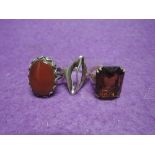 Three white metal dress rings stamped silver including carnelian and stylised