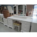 A modern painted dressing table, mirror, stool and bedside drawers