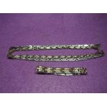 Two articulated steel necklaces and a similar bracelet
