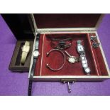 A vintage jewellery box containing a small selection of wrist watches including Seiko 330176, Buler,