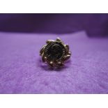 A lady's dress ring having a small Mexican coin in a moulded mount on a 9ct gold loop, size P