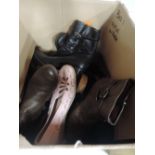 A mixed box of ladies boots and shoes in a variety of sizes and styles.
