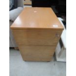 A golden oak effect filing cabinet